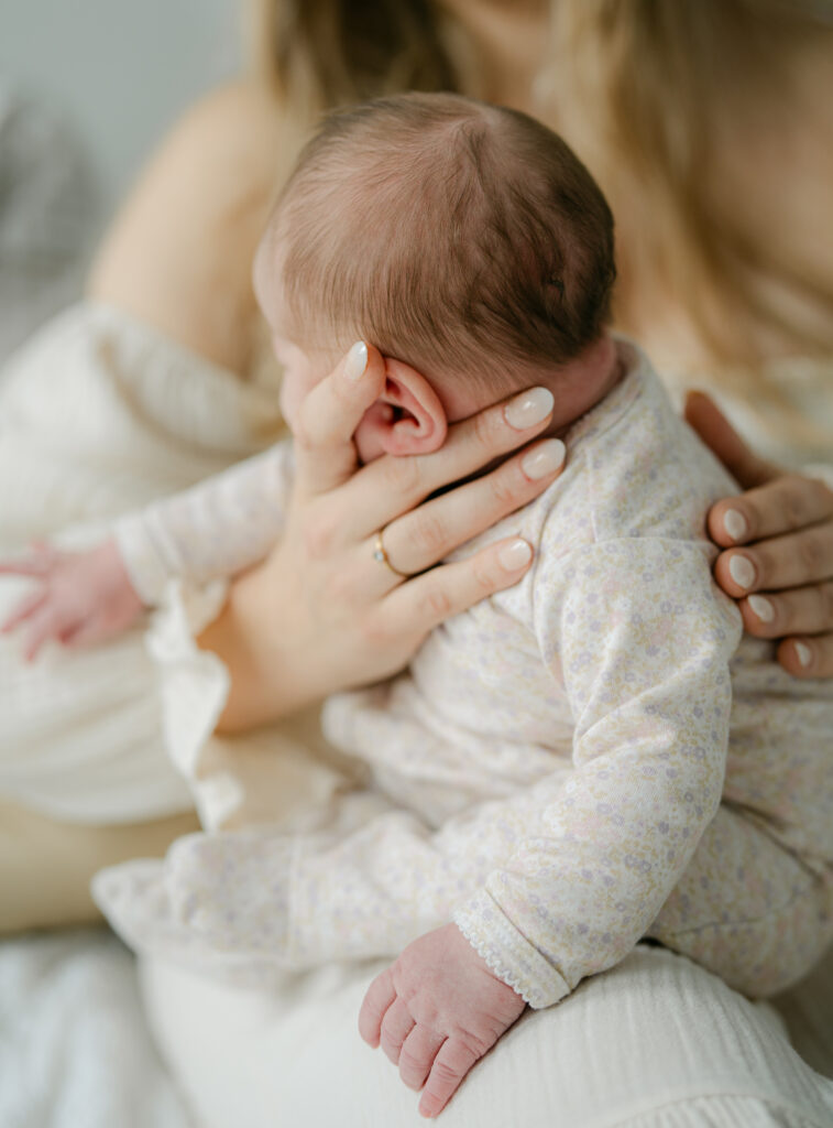 photograph of a mom holding a newborn